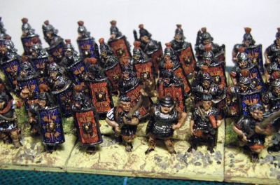 Early Imperial Roman Legionaries
Old Glory legionaries with Donnington, Corvus Belli and Essex officers and LBMS shield transfers. A rare "on the painting table" shot as they have not yet been matt varnished or had static grass added to the bases. 
Keywords: EIR